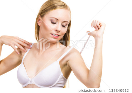 Young woman holding bra strap Young woman holding bra strap 135840912