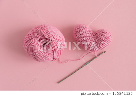 Crocheted Hearts with Yarn and crochet. Handmade Valentines Day Craft Flatlay Crocheted Hearts with Yarn and crochet. Handmade Valentines Day Craft Flatlay 135841125