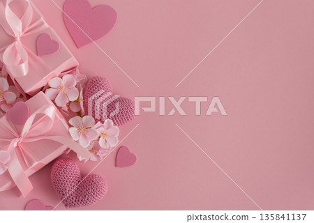 Gift Boxes, Knitted Hearts and Sakura Flowers. Romantic Valentines Day Flatlay on Pink Background 135841137