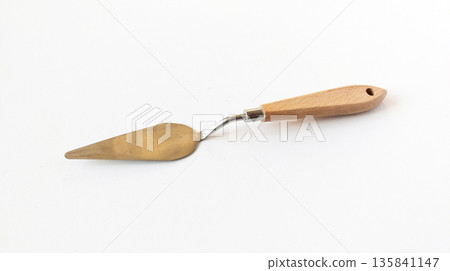 Art palette knife lie on a white background. Painting palette knife with wooden handle. 135841147