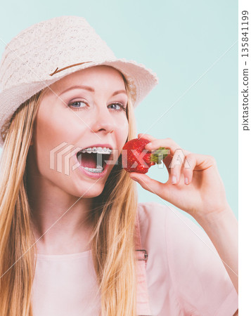 Happy woman holding strawberries Happy woman holding strawberries 135841199