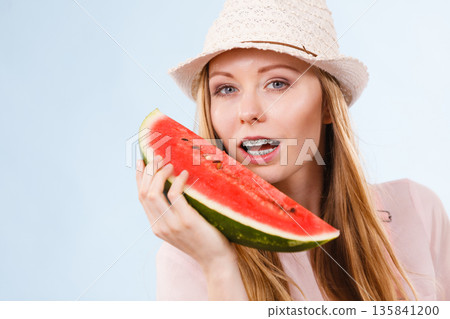 Happy woman holding watermelon 135841200