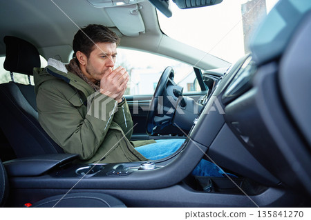 Fatigued man freezing inside car with heating problem in winter Fatigued man freezing inside car with heating problem in winter 135841270