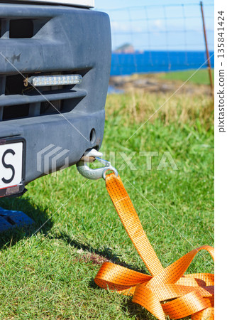 Tow hook with orange strap on car. Towing equipment. Tow hook with orange strap on car. Towing equipment. 135841424