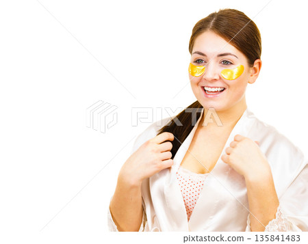 Woman with gold patches under eyes Woman with gold patches under eyes 135841483