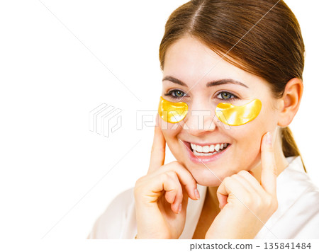 Woman with gold patches under eyes Woman with gold patches under eyes 135841484