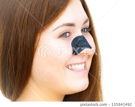 Woman with nose mask pore strips 135841492