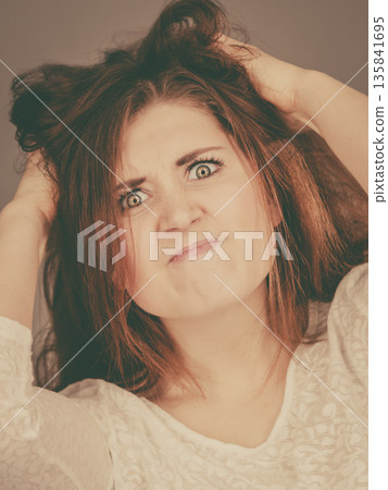 Attractive woman having angry frustrated face expression Attractive woman having angry frustrated face expression 135841695