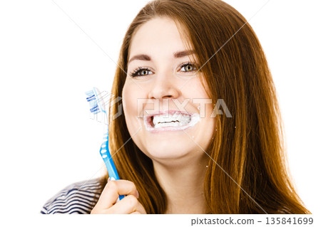 Woman brushing cleaning teeth. 135841699