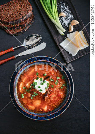 Bowl of red beetroot soup borscht with white cream 135841743