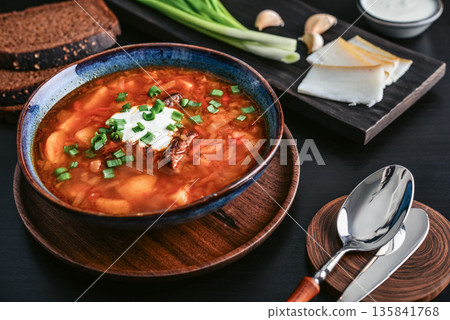 Bowl of red beetroot soup borscht with white cream 135841768
