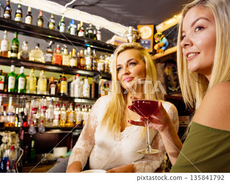 Girl with alcohol glass in pub club Girl with alcohol glass in pub club 135841792