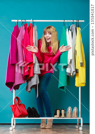 Woman choosing clothes in mall or wardrobe Woman choosing clothes in mall or wardrobe 135841817