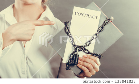 woman holding in hands contract and chain with padlock woman holding in hands contract and chain with padlock 135841825