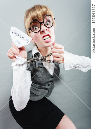 Furious woman with chained hands and contract 135841827