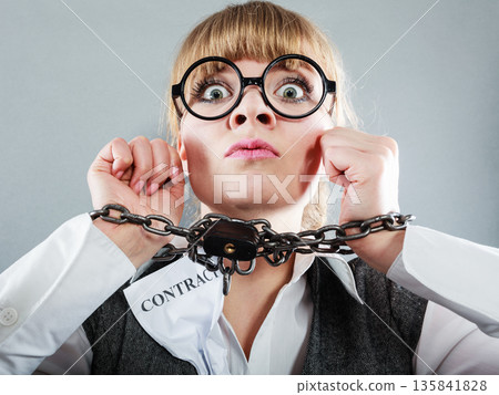 Furious woman with chained hands and contract Furious woman with chained hands and contract 135841828