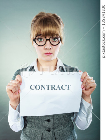unhappy business woman showing crumpled contract unhappy business woman showing crumpled contract 135841830