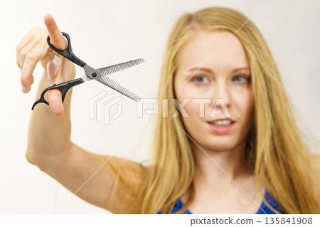 Girl with scissors thinning shears Girl with scissors thinning shears 135841908