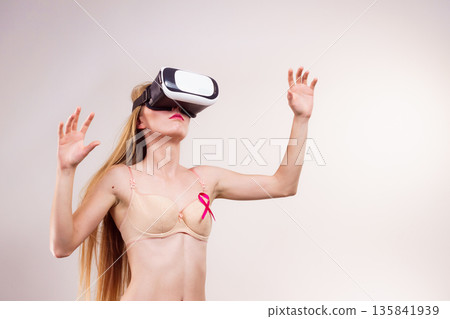 Girl in bra pink cancer ribbon and vr box 135841939