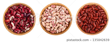 variegated kidney bean in wooden bowl isolated on white background. Top view. Flat lay variegated kidney bean in wooden bowl isolated on white background. Top view. Flat lay 135842639