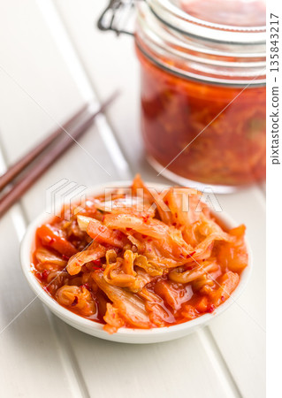 Fermented cabbage. Kimchi. Korean food in bowl on white table. Fermented cabbage. Kimchi. Korean food in bowl on white table. 135843217