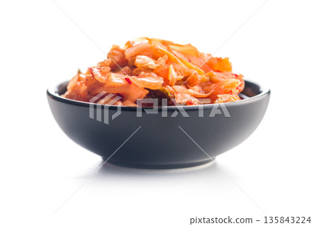Fermented cabbage. Kimchi. Korean food in bowl isolated on white background. Fermented cabbage. Kimchi. Korean food in bowl isolated on white background. 135843224