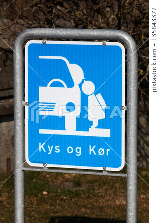 Kiss and drive area road sign in front of a school in Denmark Kiss and drive area road sign in front of a school in Denmark 135843372