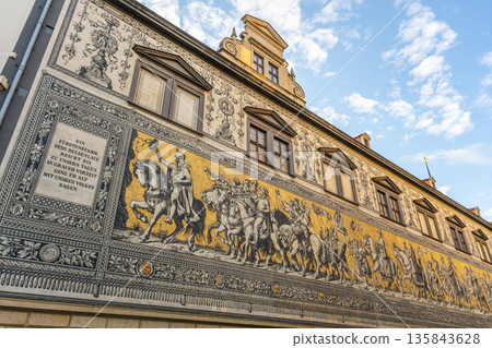 This mural The Procession of Princes displays a mounted procession of Saxony's rulers. It is located on the wall of a building in Dresden. Visitors can view this artwork showcasing history and culture This mural The Procession of Princes displays a mounted procession of Saxony's rulers. It is located on the wall of a building in Dresden. Visitors can view this artwork showcasing history and culture 135843628
