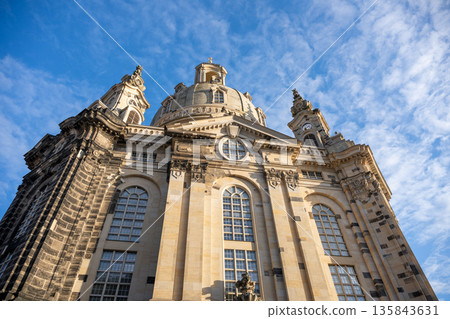 Frauenkirche is a church in Dresden, Germany. It features a large dome and stands tall against a blue sky. People visit this site during Christmas celebrations each year. Frauenkirche is a church in Dresden, Germany. It features a large dome and stands tall against a blue sky. People visit this site during Christmas celebrations each year. 135843631