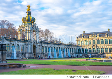Visitors stroll through the Zwinger complex in Dresden, Germany. The palatial architecture and gardens create a festive atmosphere during the Christmas season. Visitors stroll through the Zwinger complex in Dresden, Germany. The palatial architecture and gardens create a festive atmosphere during the Christmas season. 135843643