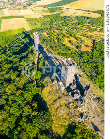 Perched atop a hill, the Hazmburk castle ruins showcase medieval architecture and offer breathtaking views of the surrounding Central Bohemian Uplands. Perched atop a hill, the Hazmburk castle ruins showcase medieval architecture and offer breathtaking views of the surrounding Central Bohemian Uplands. 135843672