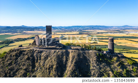 Nestled in the Central Bohemian Uplands, Hazmburk Castle ruins offer stunning aerial views of the surrounding landscape in Czechia, reflecting the grandeur of its medieval past. 135843699