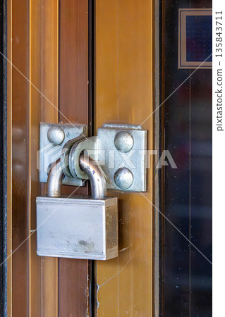 Door secured with padlock Door secured with padlock 135843711