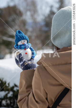 Holding a snowman Holding a snowman 135843826
