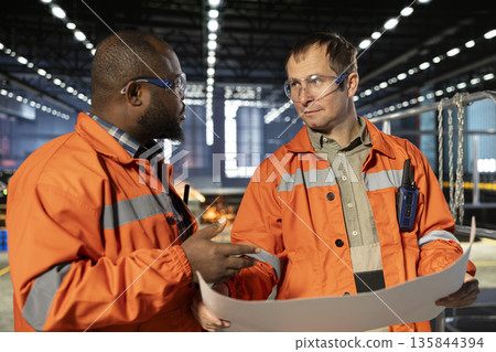 Industrial staff team overseeing fabrication tools in heavy industry plant, showing engineering concepts and workforce responsibility. Operation requirements of manufacturing facility. 135844394
