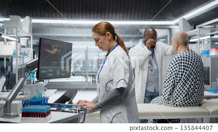 Nurse records clinical trial data during a drug study with a patient, documenting reactions and dosage effects contributing to product development and pharmacology research. Camera A. Nurse records clinical trial data during a drug study with a patient, documenting reactions and dosage effects contributing to product development and pharmacology research. Camera A. 135844407