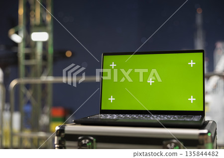 Green screen laptop on industrial drilling ship used to inspect equipment integrity. Mockup notebook on offshore platform used for performing machinery checkup to ensure safety, close up 135844482