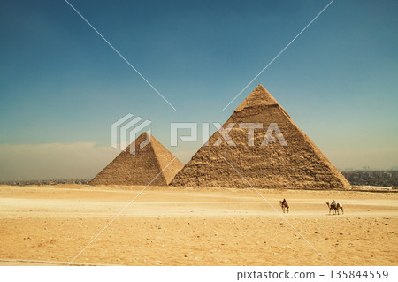 Desert Path Leading Toward the Iconic Egyptian Pyramids 135844559