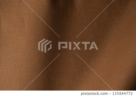 A simple composition of folded brown fabric A simple composition of folded brown fabric 135844772