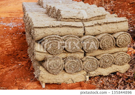 Bales of packed sod rolls are organized in neat stacks at construction site Bales of packed sod rolls are organized in neat stacks at construction site 135844896