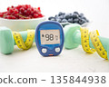 Glucometer and vegetables on desk 135844938