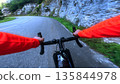 POV road cycling through rocky mountain gorge on winding alpine road 135844978