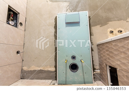 Unfinished reconstruction of bathroom or toilet with ceramic tiles installed on walls of drywall, place for lavatory and bath. Unfinished reconstruction of bathroom or toilet with ceramic tiles installed on walls of drywall, place for lavatory and bath. 135846353