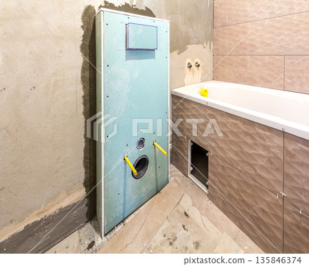 Unfinished reconstruction of bathroom or toilet with ceramic tiles installed on walls, place for lavatory and bath. Unfinished reconstruction of bathroom or toilet with ceramic tiles installed on walls, place for lavatory and bath. 135846374