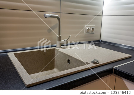 Granite sink and water faucet in new modern kitchen interior Granite sink and water faucet in new modern kitchen interior 135846413