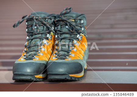A pair of leather trekking hiking winter boots on blurred background A pair of leather trekking hiking winter boots on blurred background 135846489
