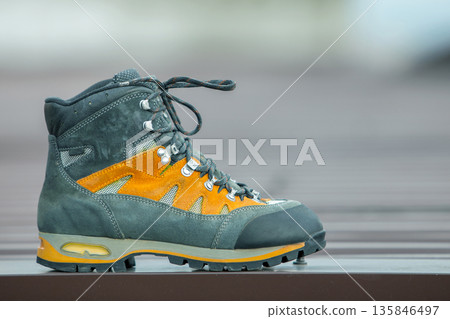 A leather trekking hiking winter boot on blurred background A leather trekking hiking winter boot on blurred background 135846497