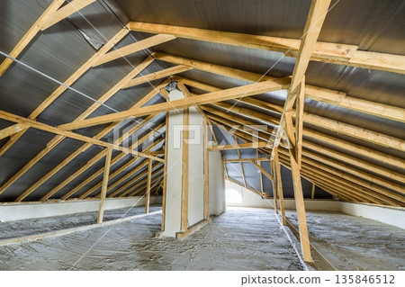 Attic of a building with wooden beams of a roof structure. Attic of a building with wooden beams of a roof structure. 135846512