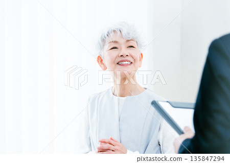 Senior woman receiving explanation Senior woman receiving explanation 135847294