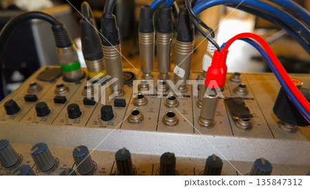 Close Up of Audio Cables and Connectors Plugged into Mixer Close Up of Audio Cables and Connectors Plugged into Mixer 135847312